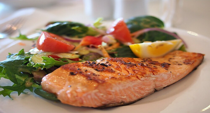 dinner plate with salmon, lemon and veggies
